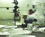 White foam pieces and workshop equipment during construction of the large sculpture