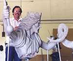 Artist beside the rider's raised arm and unfinished cloak