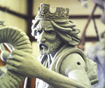 Profile detail of the crowned rider's face and outstretched arm