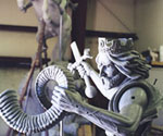 Clay rider viewed from the side, showing the armor, cloak and flowing hair