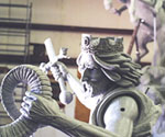 Side view of the crowned rider and draped cloak on the clay model