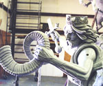 Detail of the rider's shoulder armor, flowing hair and outstretched sword arm