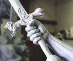 Close-up of the rider's hand gripping the sculpted sword