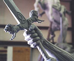 Detail of the hand around the sword hilt and the decorated crossguard
