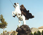 Side view of The Coming King® sculpture in an outdoor courtyard