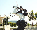 Angled courtyard view of The Coming King®, showing the horse's raised front legs and rider's cloak