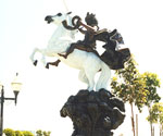Angled courtyard view of The Coming King®, showing the horse's raised front legs and rider's cloak