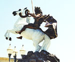 Angled courtyard view of The Coming King®, showing the horse's raised front legs and rider's cloak