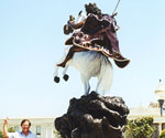 The Coming King® viewed from behind, with the rider's cloak spread out