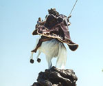 Rear view of the horse, rider and swirling base of The Coming King®