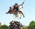 Rear three-quarter view of The Coming King® with the sword arm raised