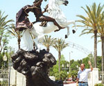 The Coming King® seen from the side among palm trees