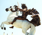 Side detail of the rider's torso and the white horse's head
