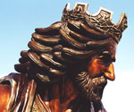 Profile detail of the crowned rider's face, beard and flowing hair