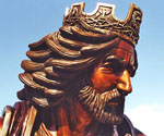 Profile detail of the crowned rider's face, beard and flowing hair