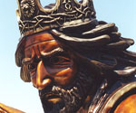 Close-up of The Coming King® rider's bronze face beneath the decorated crown