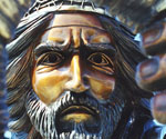 Close-up of The Coming King® rider's bronze face beneath the decorated crown