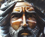 Close-up of The Coming King® rider's bronze face beneath the decorated crown