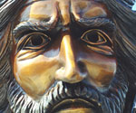 Close-up of The Coming King® rider's bronze face beneath the decorated crown