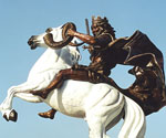 Side detail of The Coming King® rider holding the scroll above the white horse