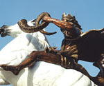 Side detail of The Coming King® rider holding the scroll above the white horse