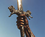 Close-up of the decorated sword hilt and gripping hand