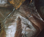 Close-up of a textured bronze surface on the sculpture base