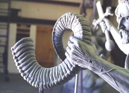 Sculpted curled scroll held by the rider