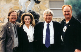 Max and Sherry Greiner standing with two visitors near sculpture displays