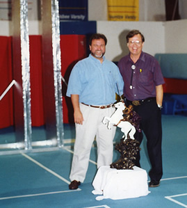 Two men beside a small sculpture in the workshop