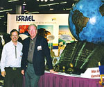 Visitors beside The Great Commission® at an exhibition booth
