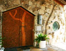 Decorated wooden studio doors beneath a stone arch