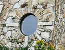 Round studio window above flowering plants