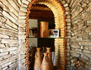 Stone alcove with wooden shelving