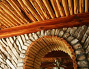 Stone arch beneath a wooden ceiling
