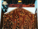Decorative wooden panel with branching designs and circular openings