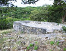 Raised stone prayer patio surrounded by native rocks and vegetation