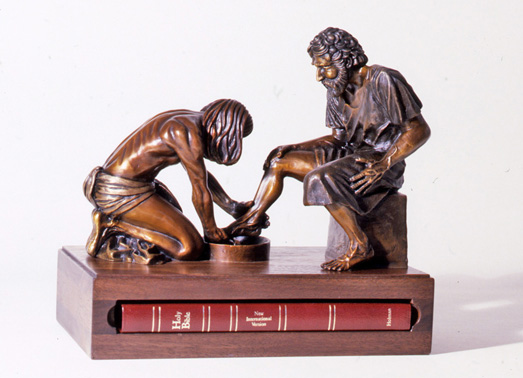 Three-quarter view of the small Divine Servant® sculpture on its Bible-shaped base