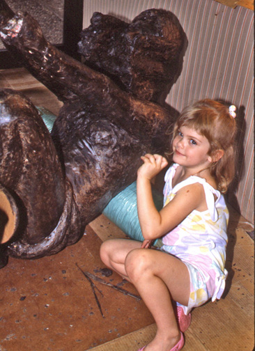 Young child seated beside the large wax figure