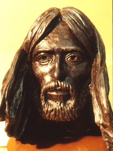 Close-up of the modeled face of Jesus, with long hair and a beard