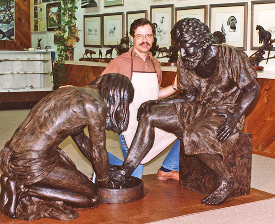 Artist posing behind Jesus and Peter in the studio