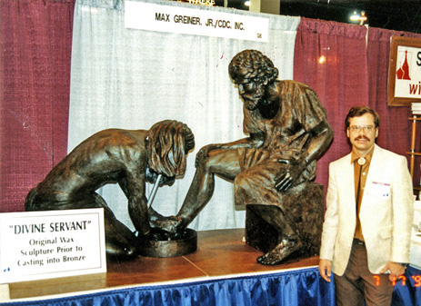 Max Greiner beside the unveiled Divine Servant® sculpture at an exhibition