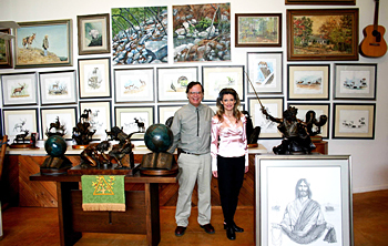 Max and Sherry Greiner standing among artwork in their gallery
