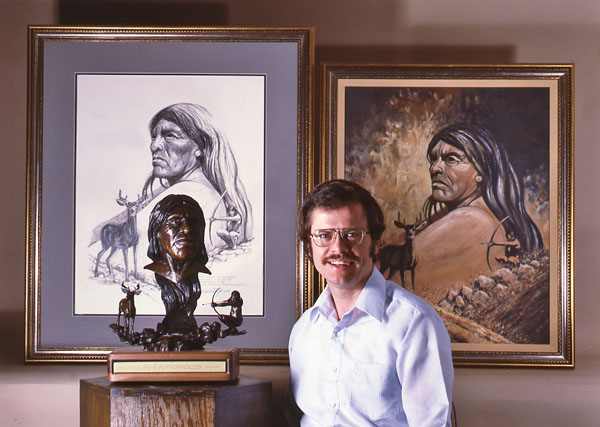 Max Greiner beside portraits and a sculpted bust of Ishi