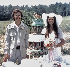 Max and Sherry Greiner beside their wedding cake outdoors